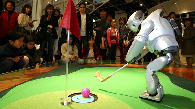 Sony's walking robot, Qrio plays golf in 2004